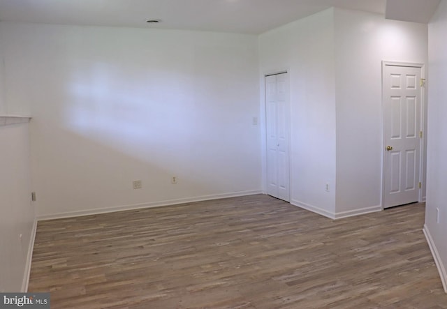 unfurnished bedroom with baseboards and wood finished floors