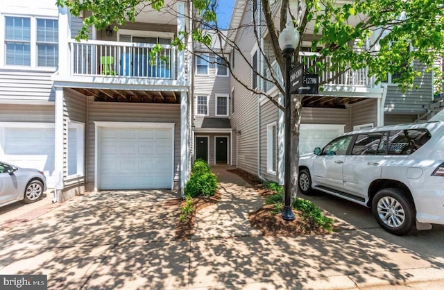 multi unit property with concrete driveway and an attached garage