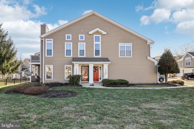 traditional-style home featuring central AC unit, a chimney, a front yard, and fence