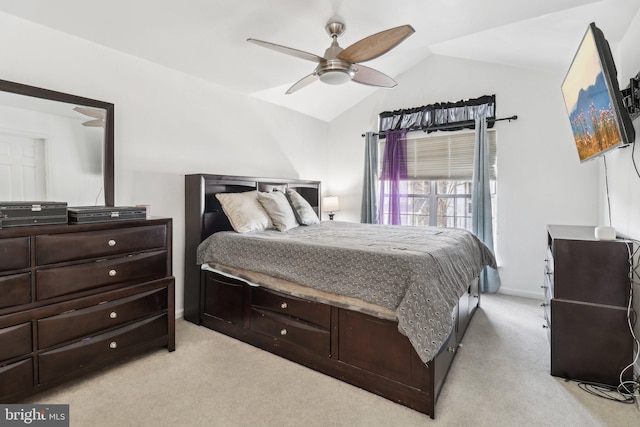 bedroom featuring a ceiling fan, light colored carpet, and vaulted ceiling