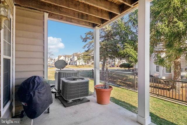 exterior space featuring cooling unit, fence, and grilling area