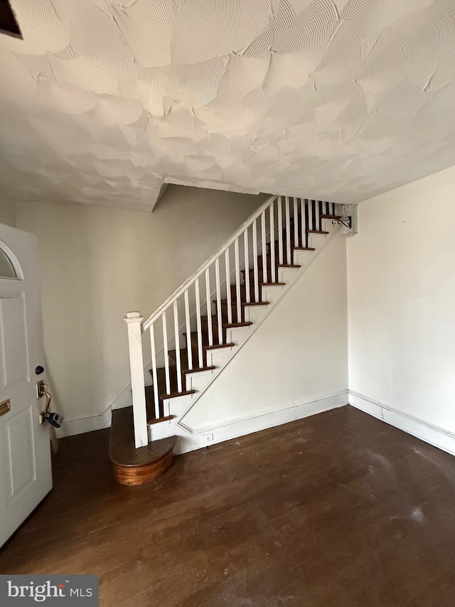 stairway featuring baseboards