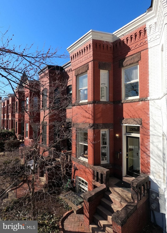 view of property featuring brick siding