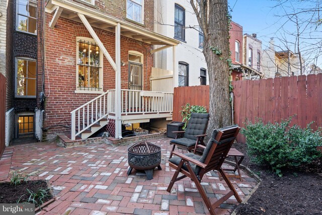 view of patio / terrace with an outdoor fire pit and fence
