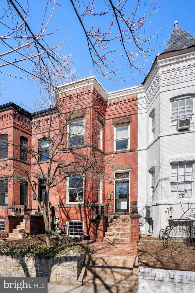 multi unit property with cooling unit, brick siding, and central AC unit