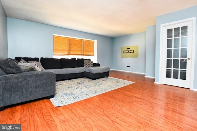 living area with wood finished floors and baseboards