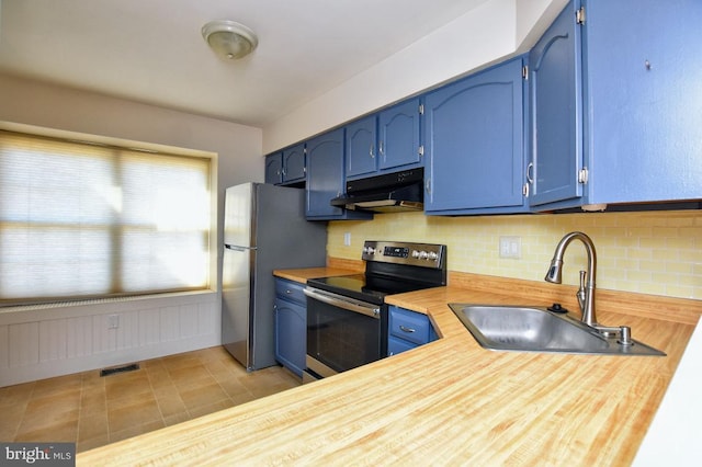 kitchen featuring under cabinet range hood, blue cabinetry, and appliances with stainless steel finishes