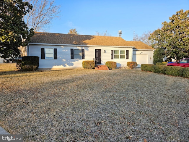 single story home featuring a garage and driveway