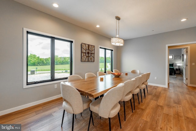 dining space with light wood-style floors, recessed lighting, and baseboards