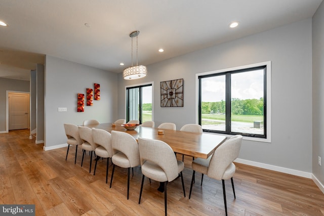 dining space featuring light wood-style flooring, baseboards, and recessed lighting