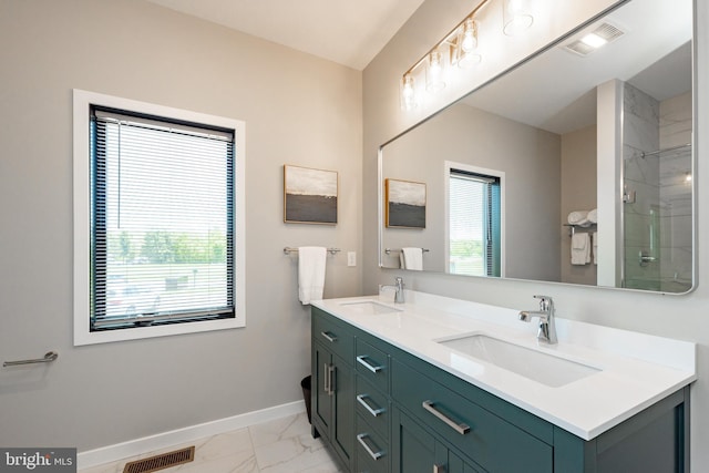 full bath with marble finish floor, baseboards, visible vents, and a sink