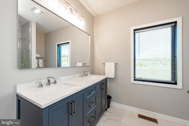 full bathroom with marble finish floor, a sink, visible vents, and baseboards