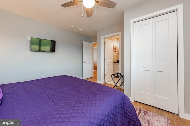 bedroom featuring light wood-style floors, a closet, and a ceiling fan