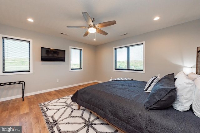 bedroom featuring baseboards, visible vents, wood finished floors, and recessed lighting