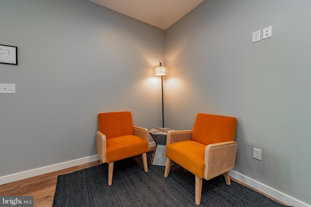 sitting room with wood finished floors and baseboards