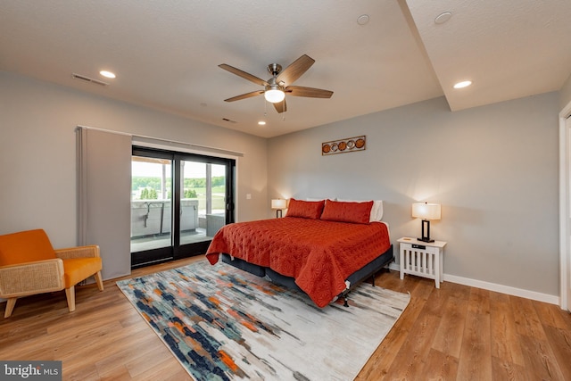 bedroom with access to outside, recessed lighting, light wood-type flooring, and baseboards