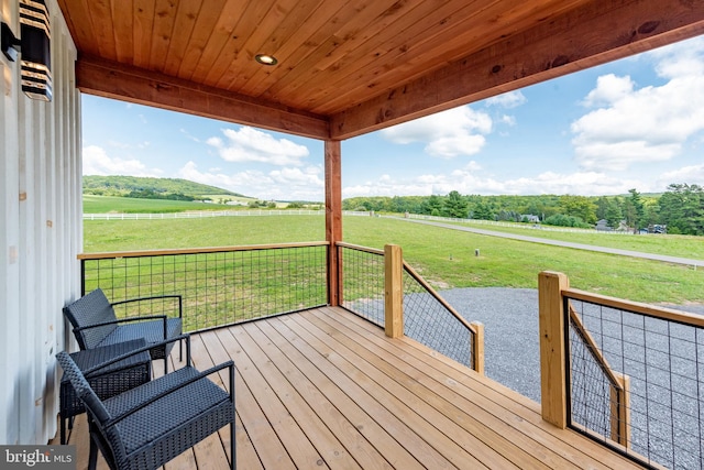 deck featuring a yard and a rural view