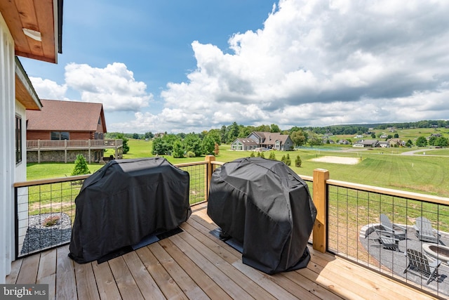 deck featuring a grill and a lawn