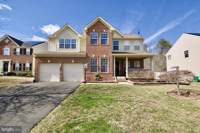 view of front of house featuring aphalt driveway, brick siding, covered porch, a garage, and a front lawn