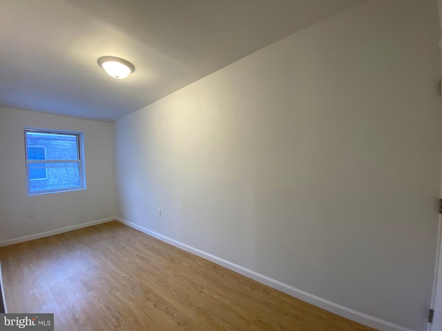 unfurnished room featuring light wood-type flooring and baseboards