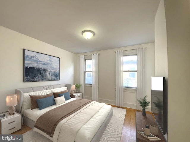 bedroom featuring baseboards and wood finished floors