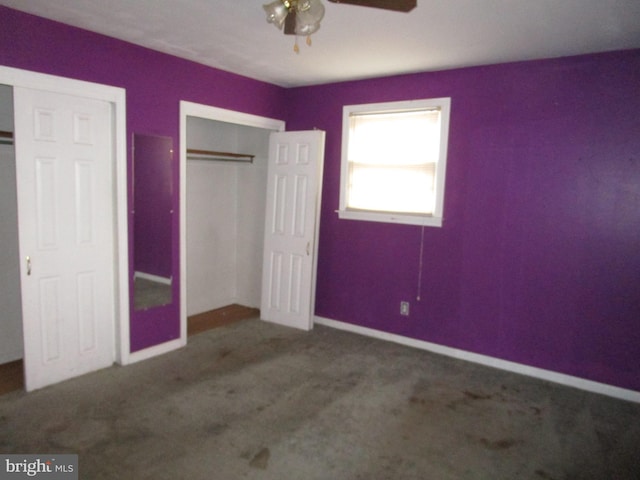 unfurnished bedroom with a closet, carpet flooring, ceiling fan, and baseboards