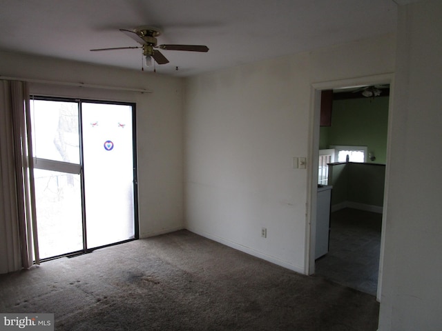 spare room with carpet flooring, a ceiling fan, and baseboards