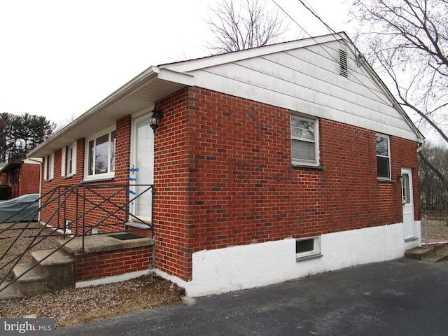 view of property exterior with brick siding