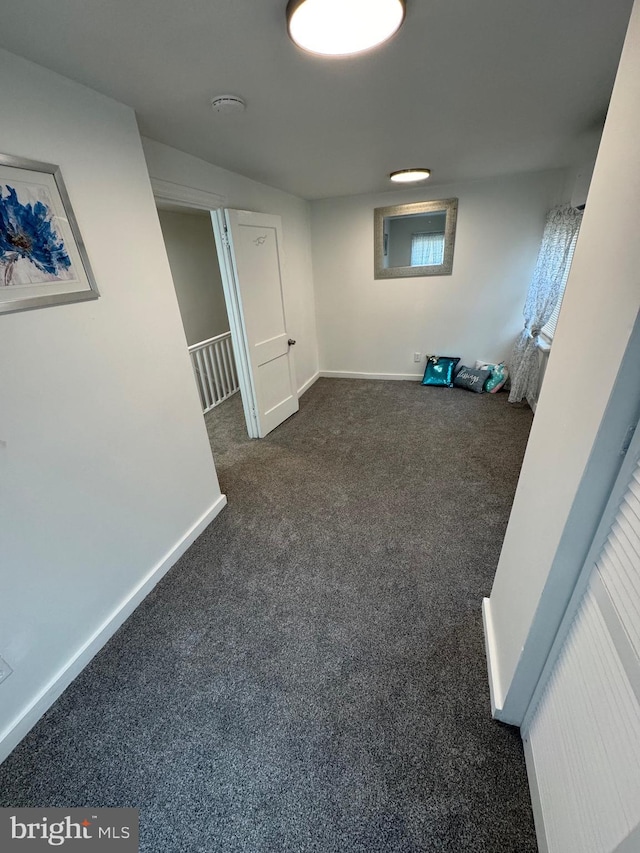 interior space featuring carpet and baseboards