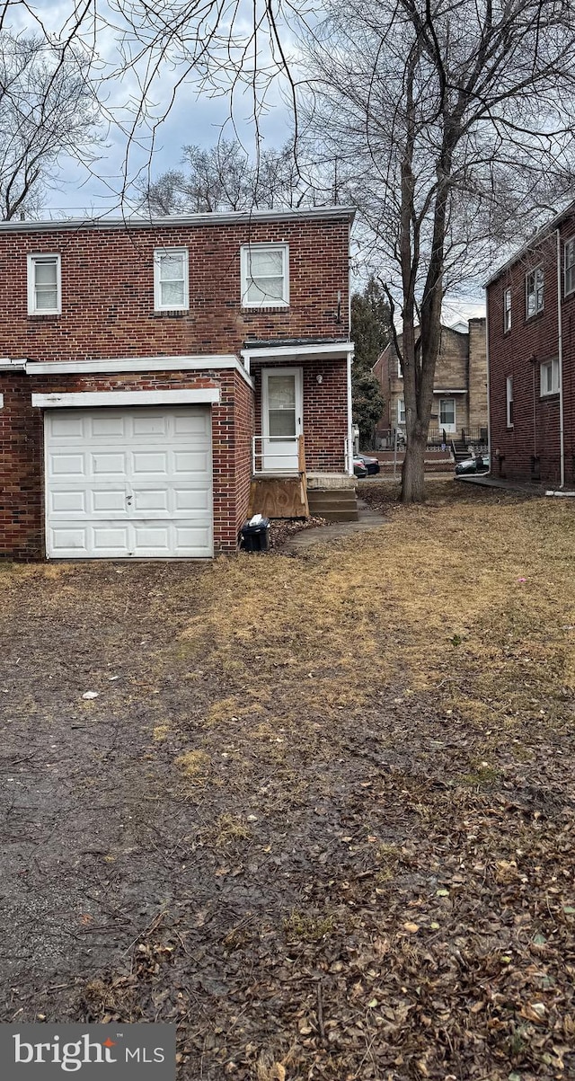 view of front of house featuring a garage and brick siding