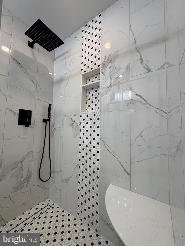 bathroom featuring a marble finish shower