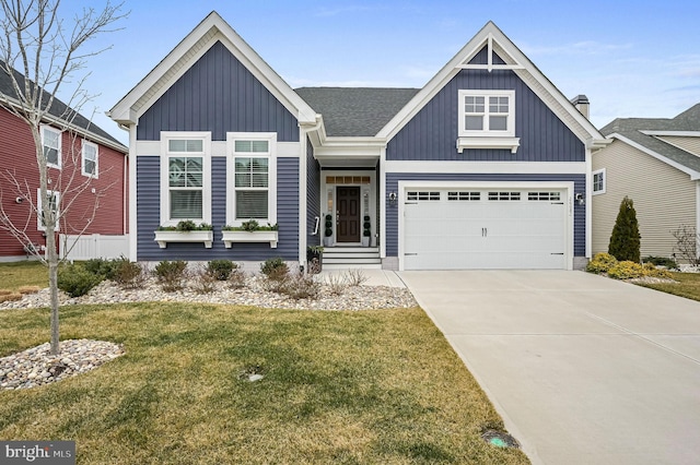 view of front of house with roof with shingles, concrete driveway, an attached garage, board and batten siding, and a front lawn