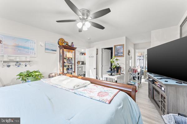 bedroom with ceiling fan and light wood-style floors