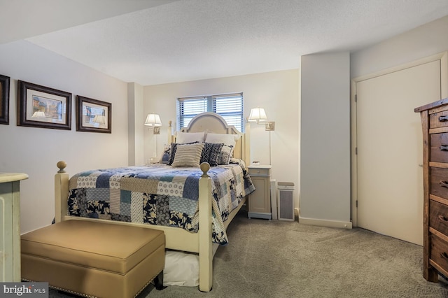 carpeted bedroom featuring a textured ceiling