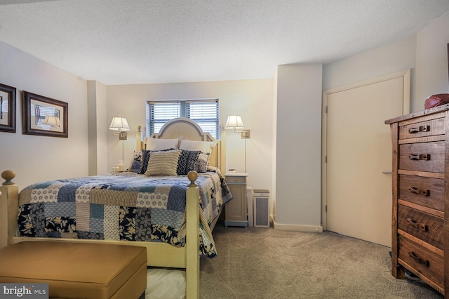 bedroom with carpet and a textured ceiling