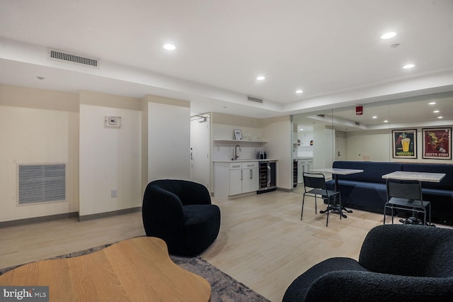 living area with wine cooler, wet bar, and visible vents