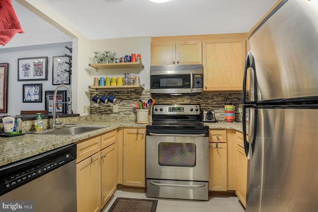 kitchen featuring light tile patterned flooring, stainless steel appliances, backsplash, and light brown cabinetry