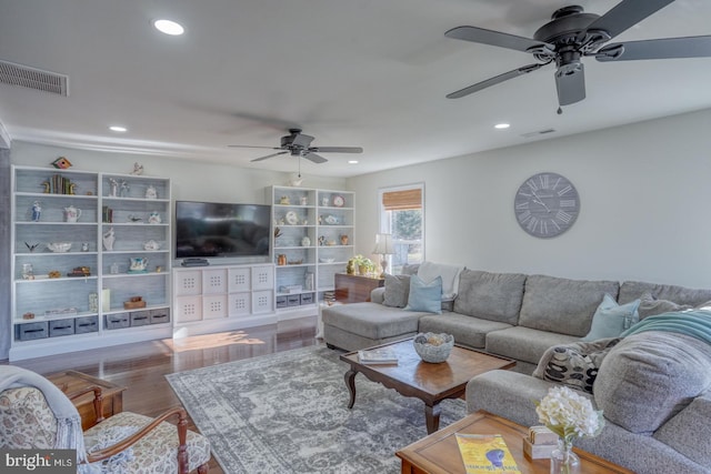 living room featuring visible vents, recessed lighting, and wood finished floors