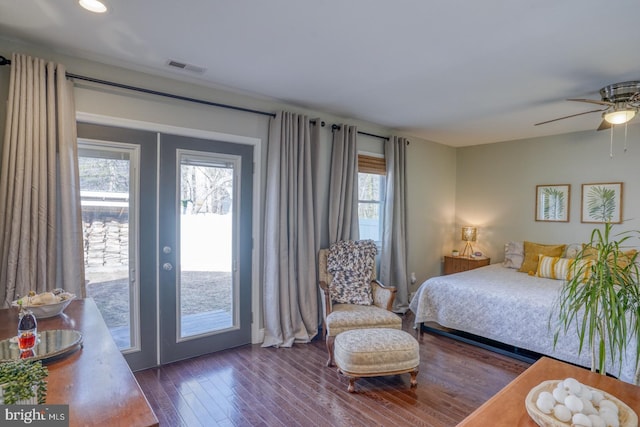 bedroom with access to outside, wood finished floors, visible vents, and french doors