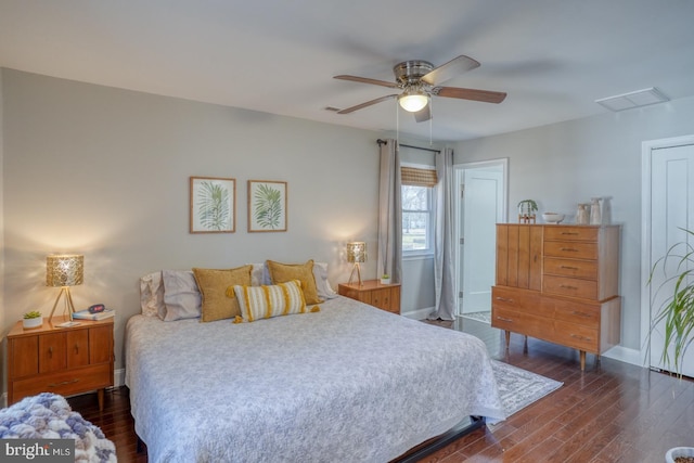 bedroom featuring visible vents, baseboards, a ceiling fan, and dark wood-style flooring