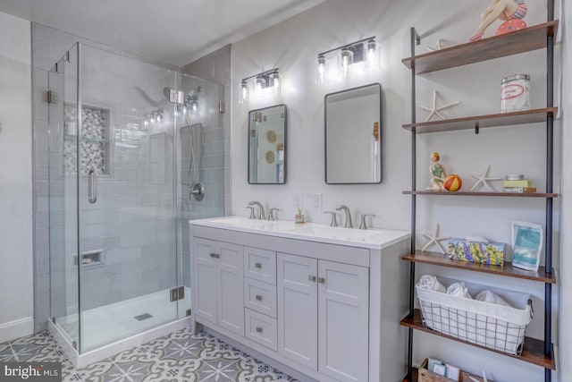 full bathroom featuring a sink, a stall shower, and double vanity