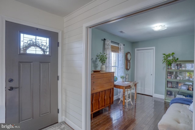 entrance foyer featuring visible vents, baseboards, and wood finished floors