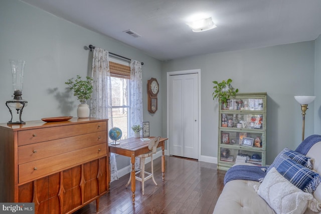 office space with visible vents, baseboards, and dark wood-style floors