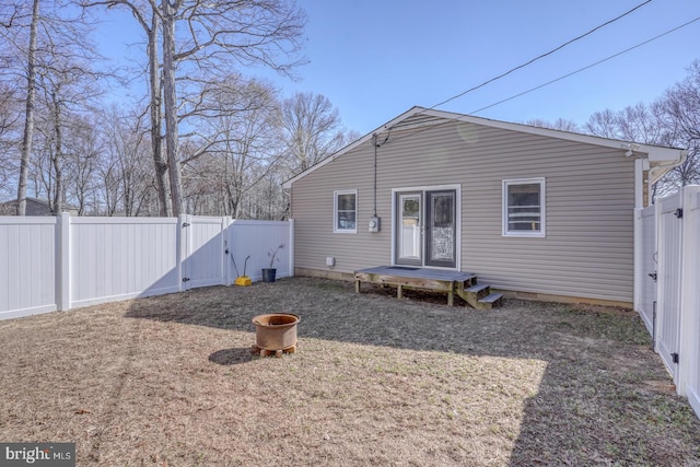 back of house featuring a gate and a fenced backyard