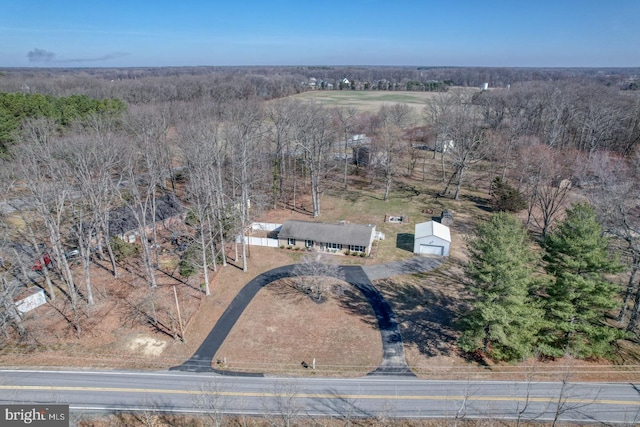 drone / aerial view featuring a view of trees