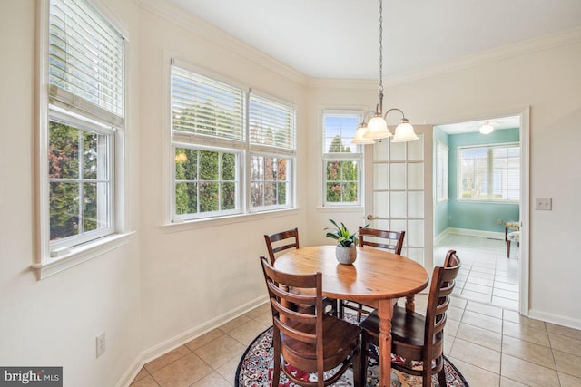 dining space with a healthy amount of sunlight, crown molding, baseboards, and light tile patterned floors