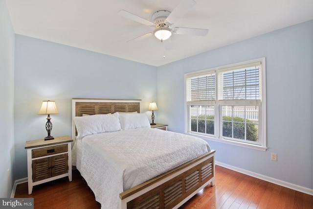 bedroom featuring hardwood / wood-style flooring, baseboards, and a ceiling fan