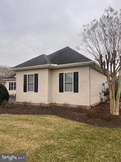 view of property exterior with a yard