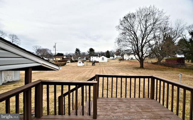 wooden terrace with a lawn