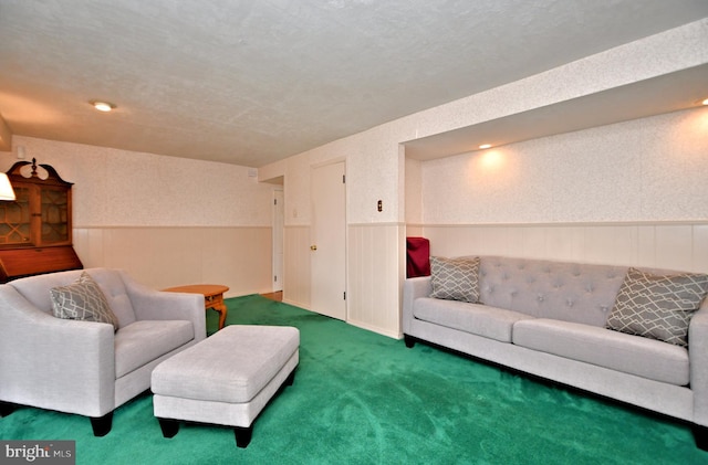 carpeted living area with a wainscoted wall and wallpapered walls